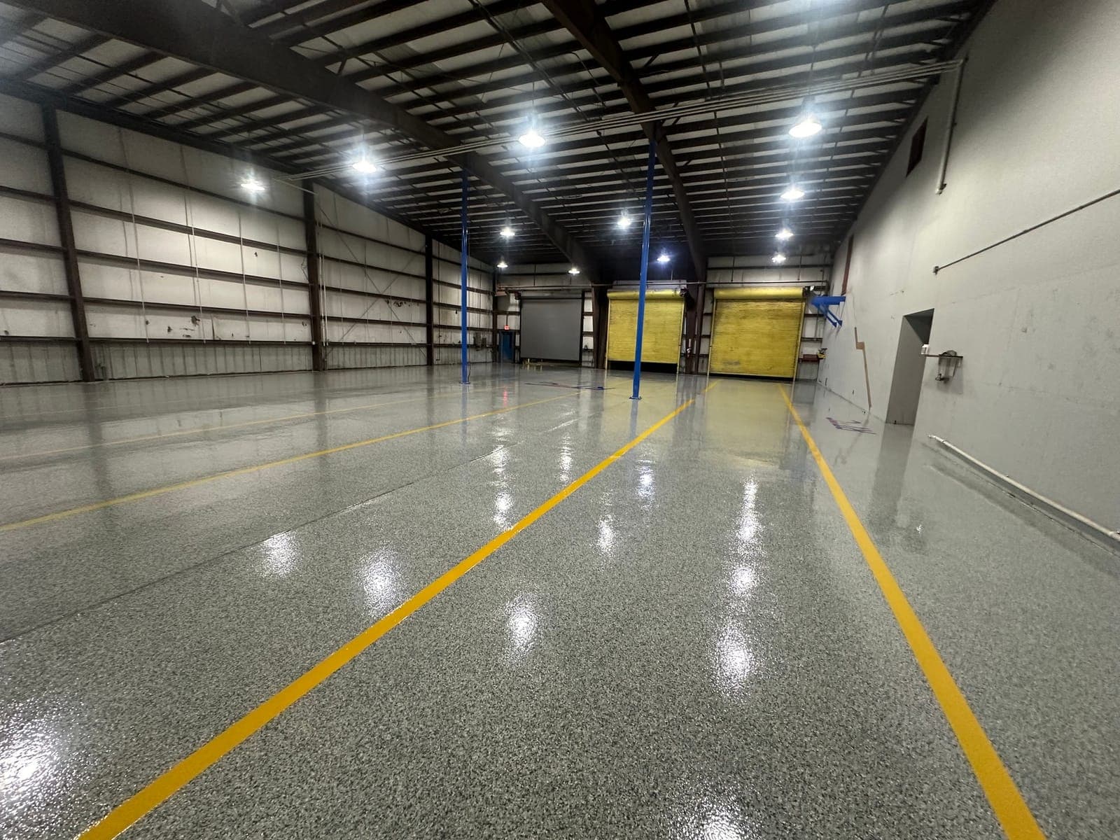 Warehouse interior with a gloss coated floor and a yellow aisle stripe