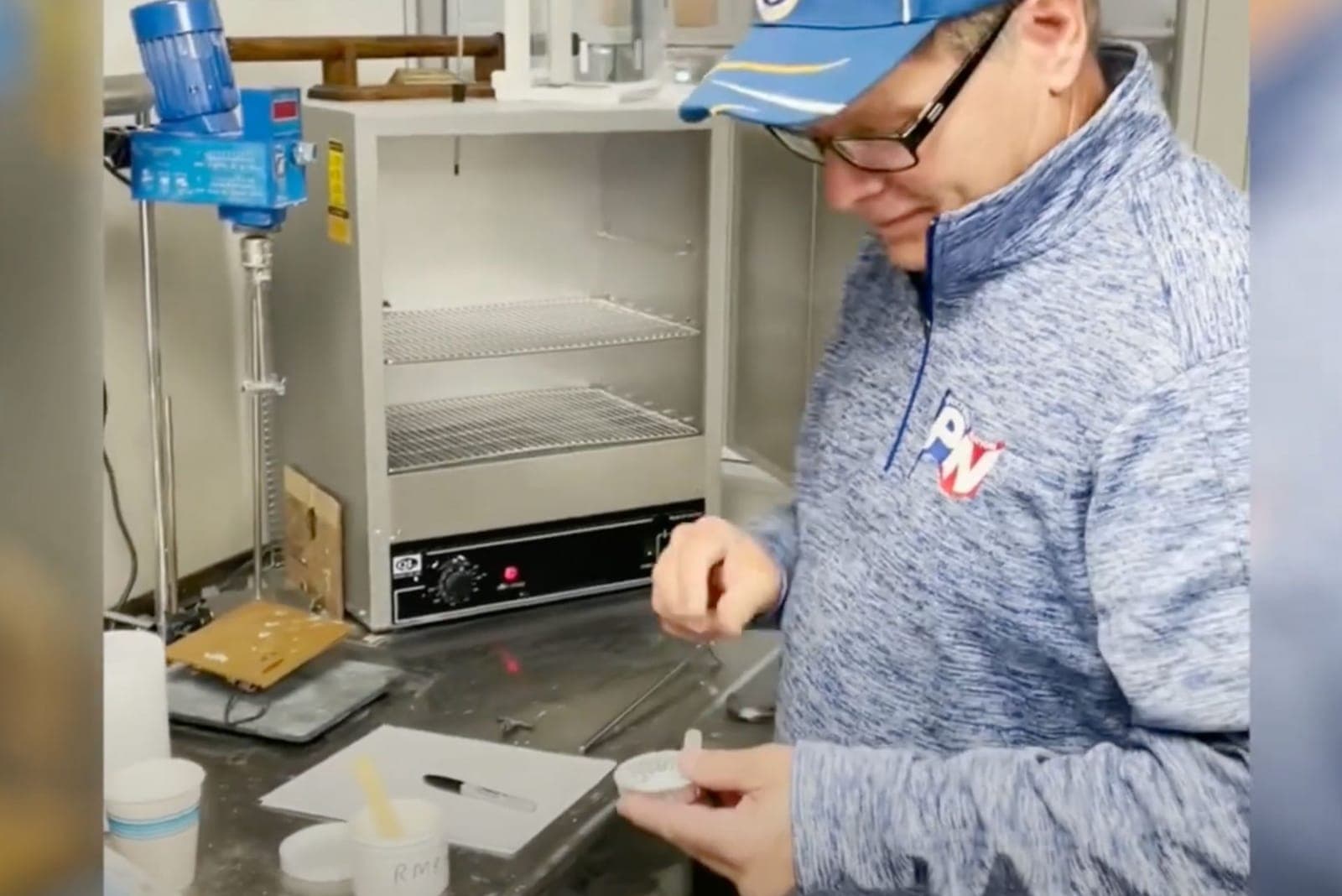 Polymer Nation lab technician preparing a coating sample at the laboratory oven