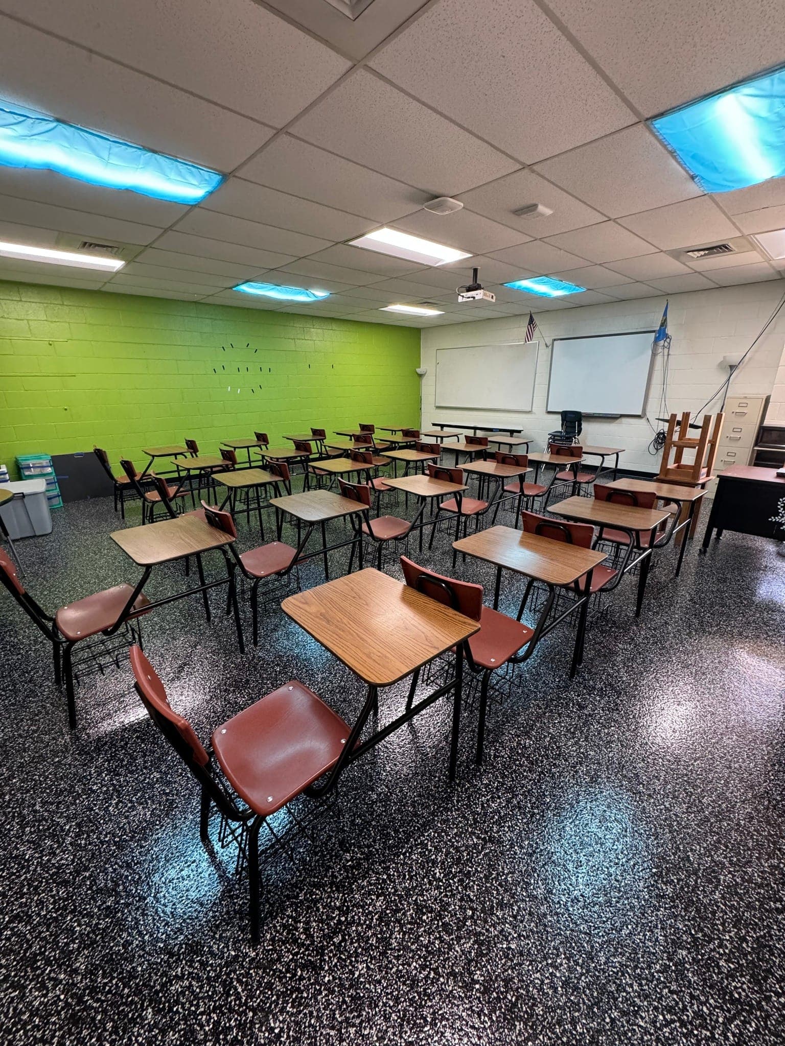 School classroom with desks on a polished decorative floor