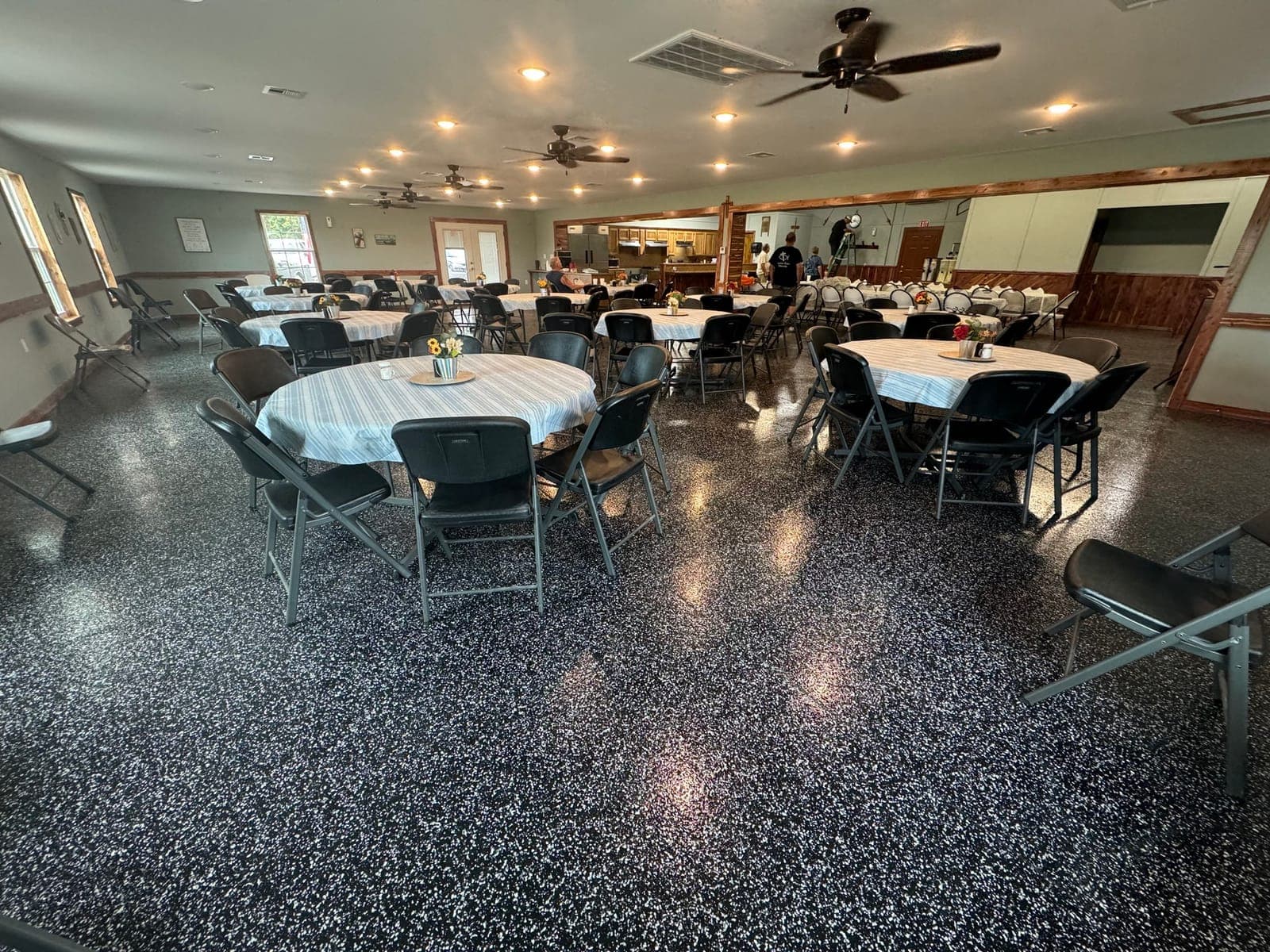 Banquet room with a decorative flake floor set for an event